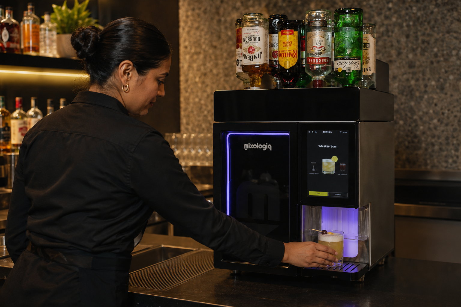 Bartender using a Mixologiq automated cocktail machine during professional service